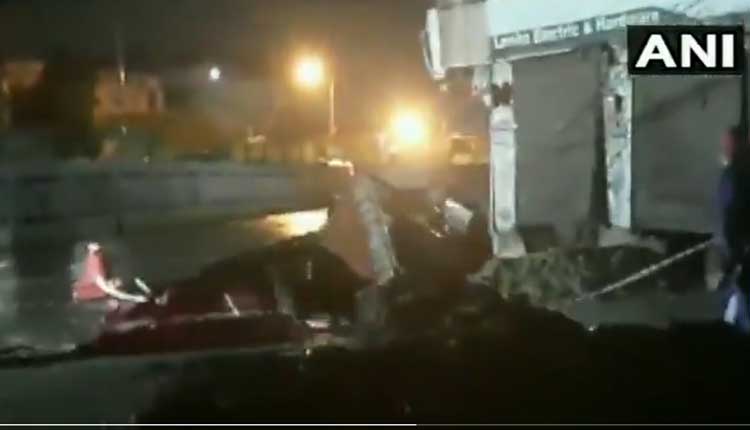 వ‌ర్షానికి రోడ్డుపై భారీ గొయ్యి.. గోతిలోకి దూసుకెళ్లిన లారీ